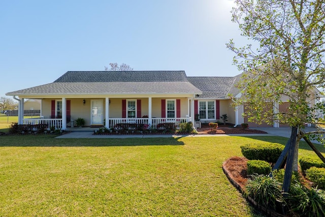 view of front of property featuring a garage, a porch, and a front yard