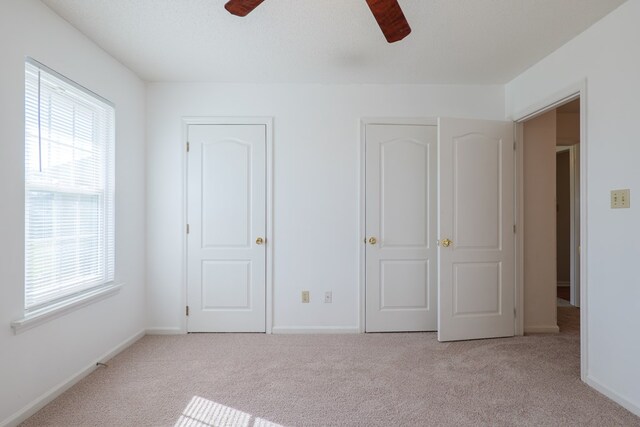 unfurnished bedroom featuring baseboards, ceiling fan, and carpet flooring