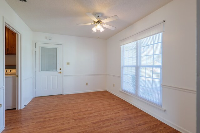 empty room featuring baseboards, light wood-type flooring, and ceiling fan