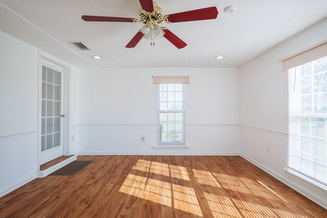 spare room featuring recessed lighting, visible vents, baseboards, and wood finished floors