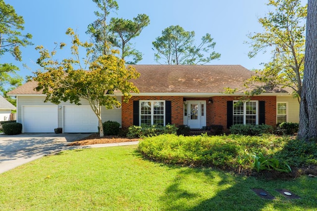 view of front of house with a garage and a front lawn