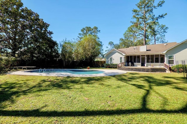 view of swimming pool with a patio, a lawn, and a sunroom