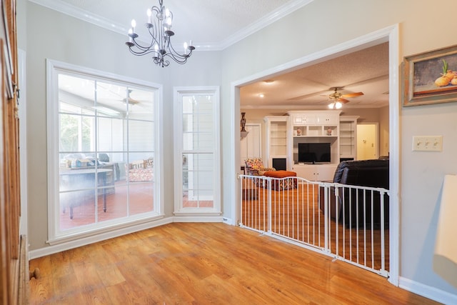 interior space featuring crown molding, light hardwood / wood-style flooring, ceiling fan with notable chandelier, and a textured ceiling