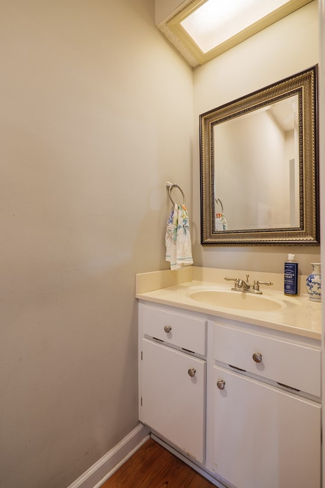 bathroom with hardwood / wood-style floors and vanity