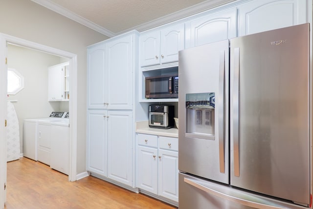 kitchen with white cabinets, light hardwood / wood-style flooring, ornamental molding, appliances with stainless steel finishes, and washing machine and clothes dryer