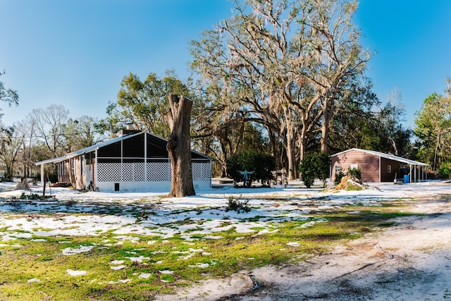 yard covered in snow with an outdoor structure