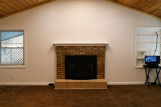 unfurnished living room with lofted ceiling, dark carpet, wooden ceiling, and a brick fireplace