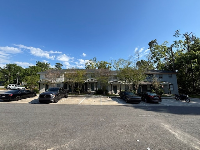 view of property featuring uncovered parking