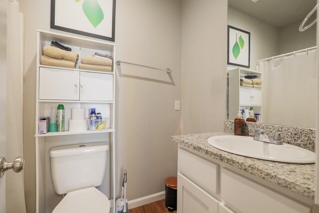 610 Baytree Rd Unit 35, Valdosta, GA 31602 - full bathroom with toilet, wood finished floors, vanity, a shower with curtain, and baseboards