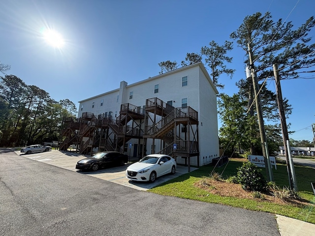 exterior space with uncovered parking and stairway