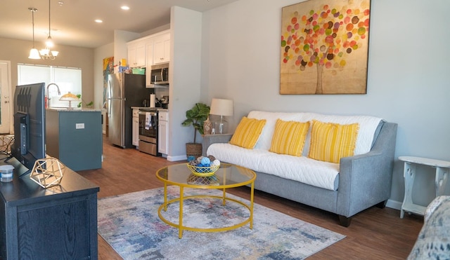 living area with dark wood-type flooring, baseboards, and recessed lighting