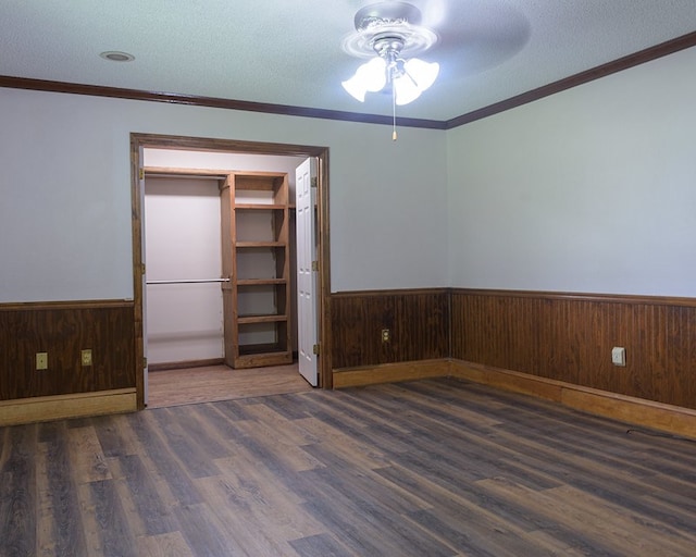 empty room featuring dark hardwood / wood-style floors and a textured ceiling