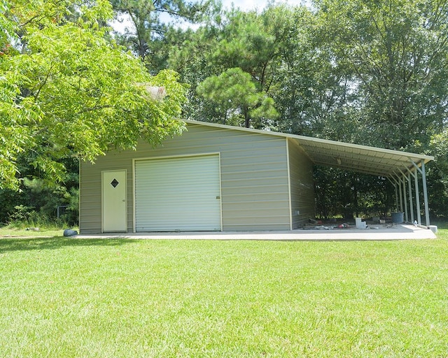 garage with a yard and a carport