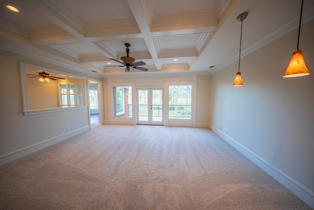 carpeted spare room featuring beamed ceiling, ornamental molding, coffered ceiling, baseboards, and ceiling fan
