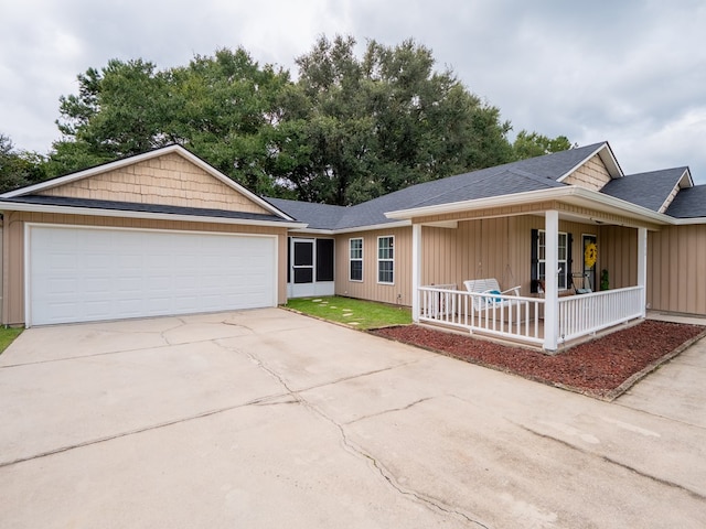 single story home featuring driveway, a porch, board and batten siding, and an attached garage