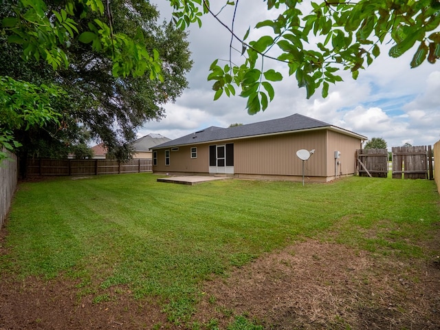 back of house with a lawn, a patio area, and a fenced backyard