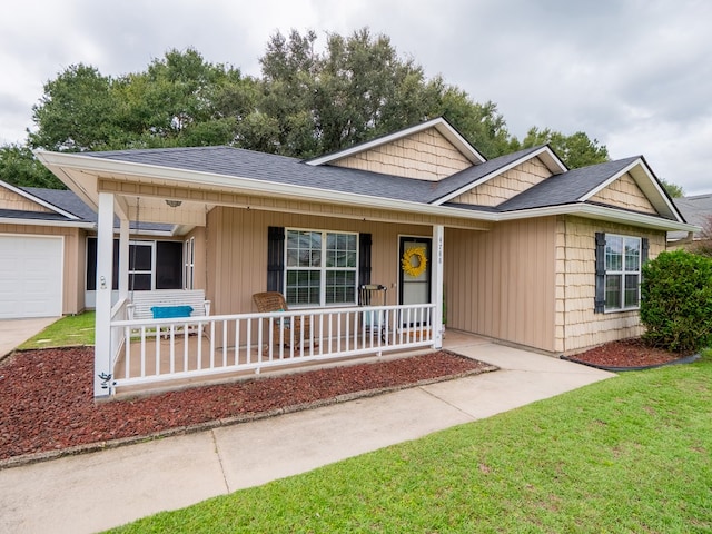 single story home with a porch, a front lawn, and a shingled roof