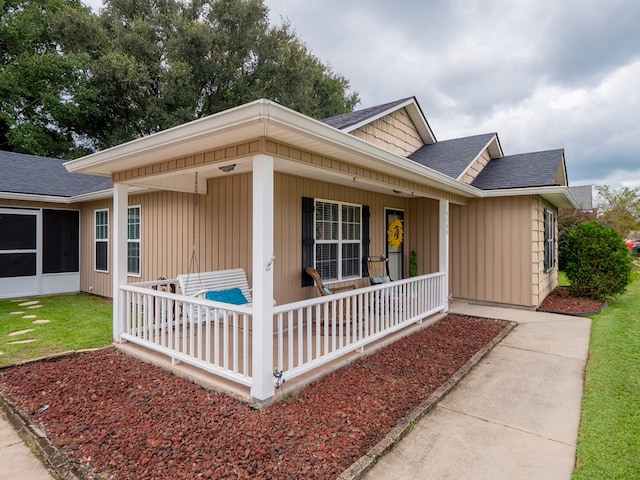 view of front facade featuring a porch and a shingled roof