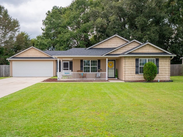 ranch-style house featuring an attached garage, covered porch, fence, driveway, and a front lawn