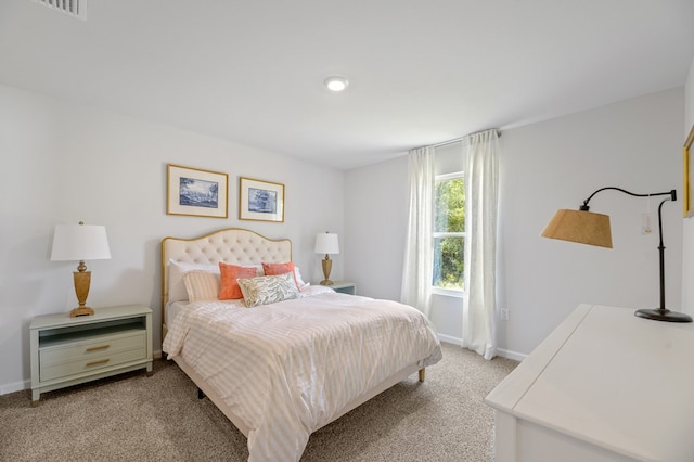 bedroom with baseboards and light colored carpet