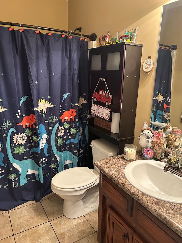 bathroom with tile patterned flooring, vanity, and toilet