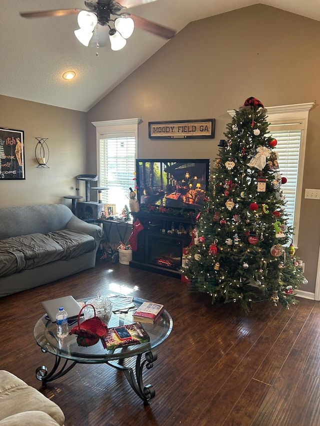 living room with ceiling fan, lofted ceiling, and dark hardwood / wood-style floors