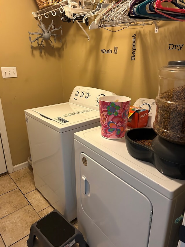 washroom with independent washer and dryer and light tile patterned floors