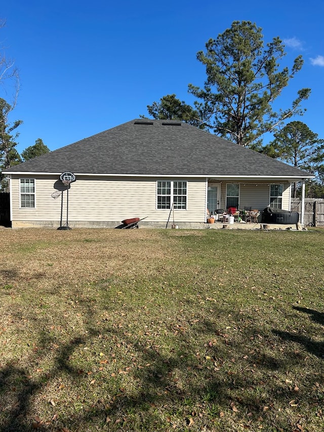 back of property featuring a patio and a lawn