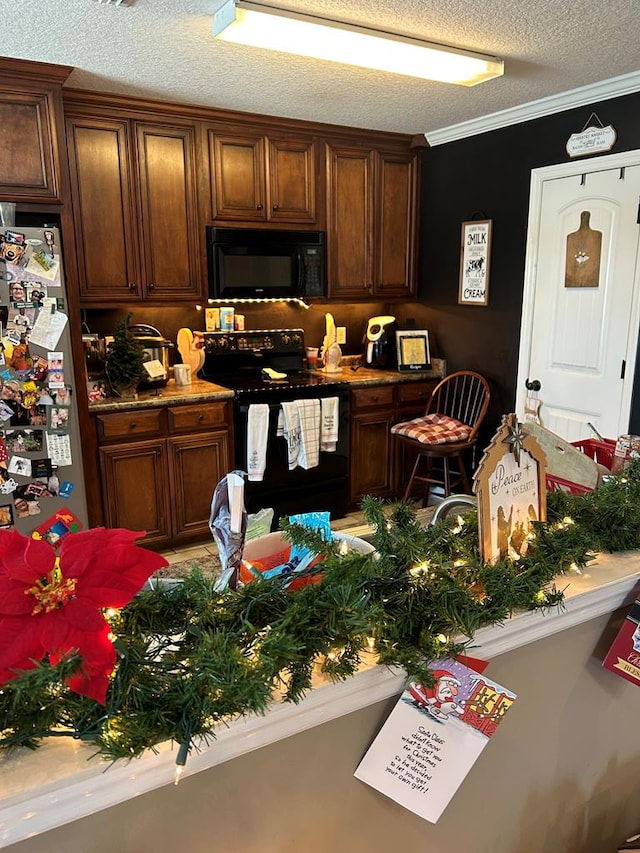 kitchen with dark brown cabinetry, ornamental molding, a textured ceiling, and black appliances