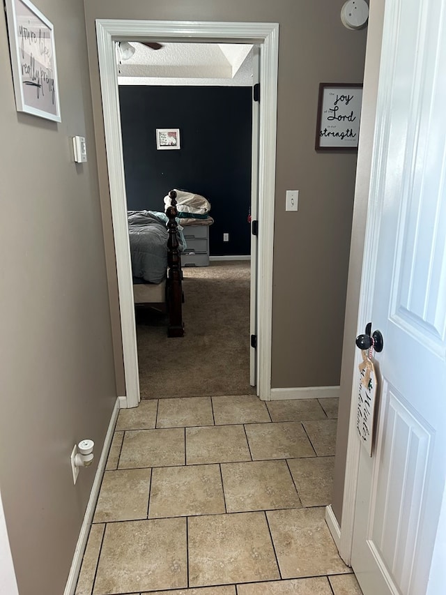 hallway featuring light carpet