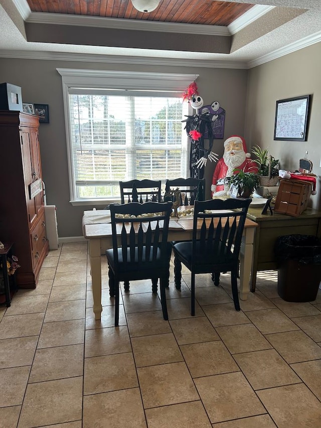 tiled dining room with crown molding, a tray ceiling, and wooden ceiling