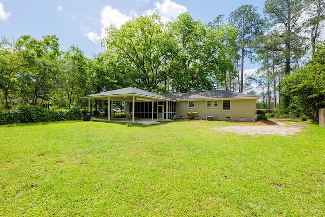 rear view of house featuring a yard