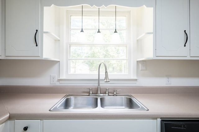 kitchen featuring white cabinetry, sink, and dishwasher