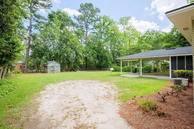 view of yard featuring central AC unit, a patio area, and a storage shed