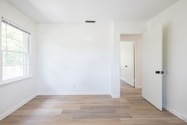 unfurnished room with light wood-type flooring