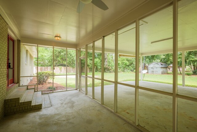 unfurnished sunroom with ceiling fan