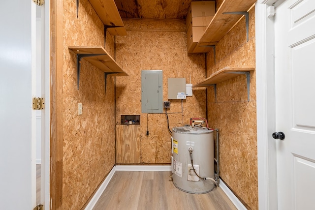 utility room featuring electric water heater and electric panel