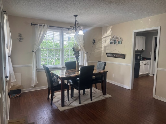 dining room with baseboards, dark wood-style floors, a textured ceiling, and a chandelier