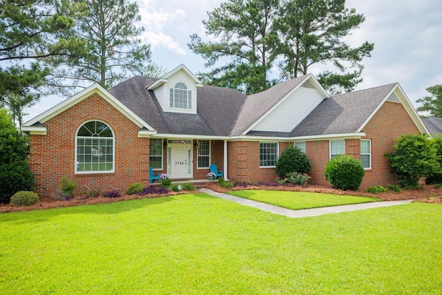 view of front of house with a front yard and a porch