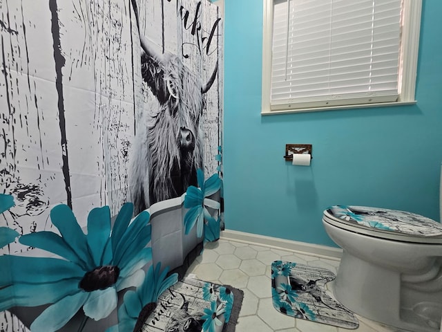 bathroom with tile patterned floors and toilet