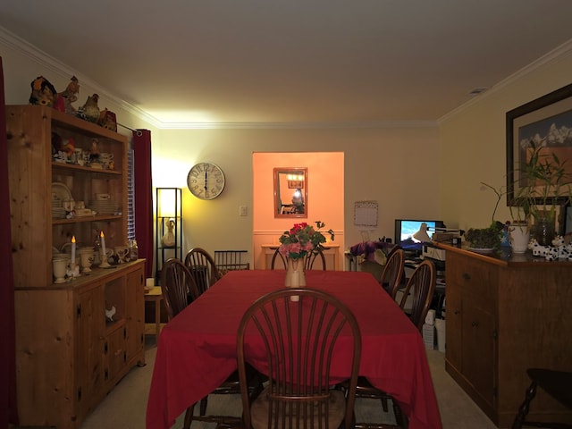 carpeted dining area featuring ornamental molding