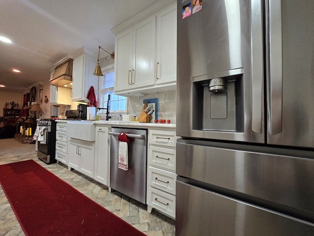 kitchen featuring stainless steel appliances, white cabinetry, and backsplash