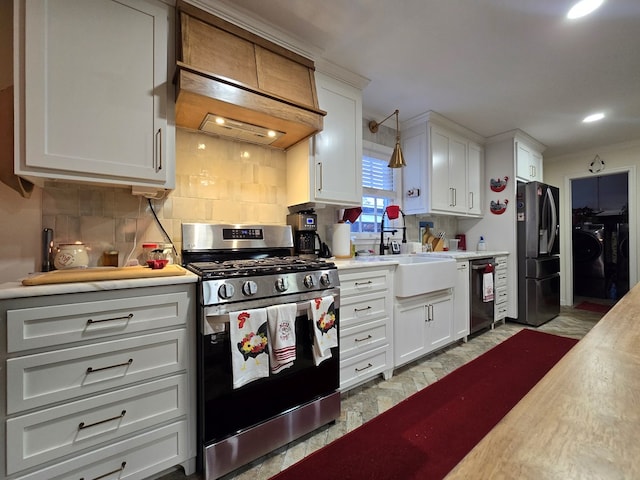 kitchen featuring white cabinetry, appliances with stainless steel finishes, backsplash, and pendant lighting