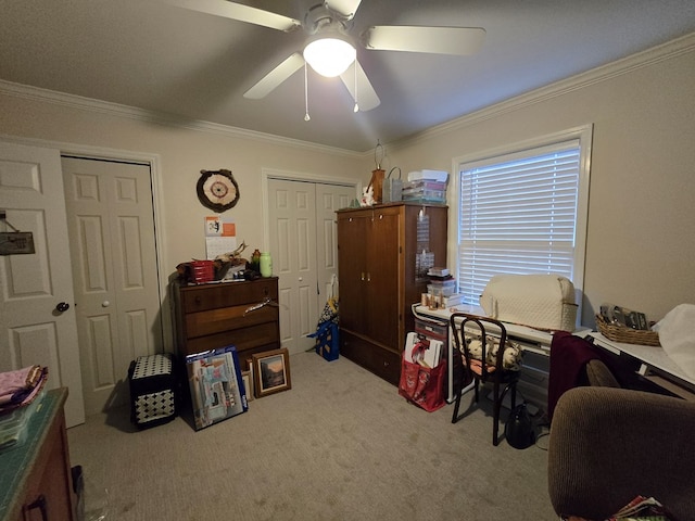 interior space with ceiling fan, light colored carpet, and ornamental molding