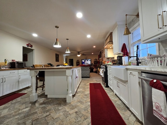 kitchen with white cabinetry, pendant lighting, stainless steel appliances, and a kitchen breakfast bar