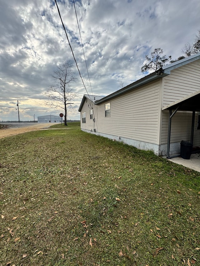 view of property exterior featuring a patio area and a yard