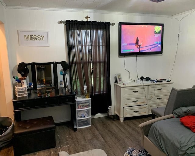 bedroom with dark wood-type flooring and crown molding