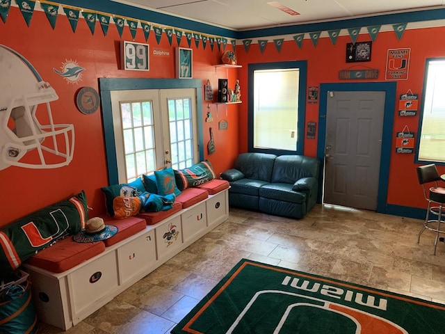rec room featuring french doors and stone finish floor