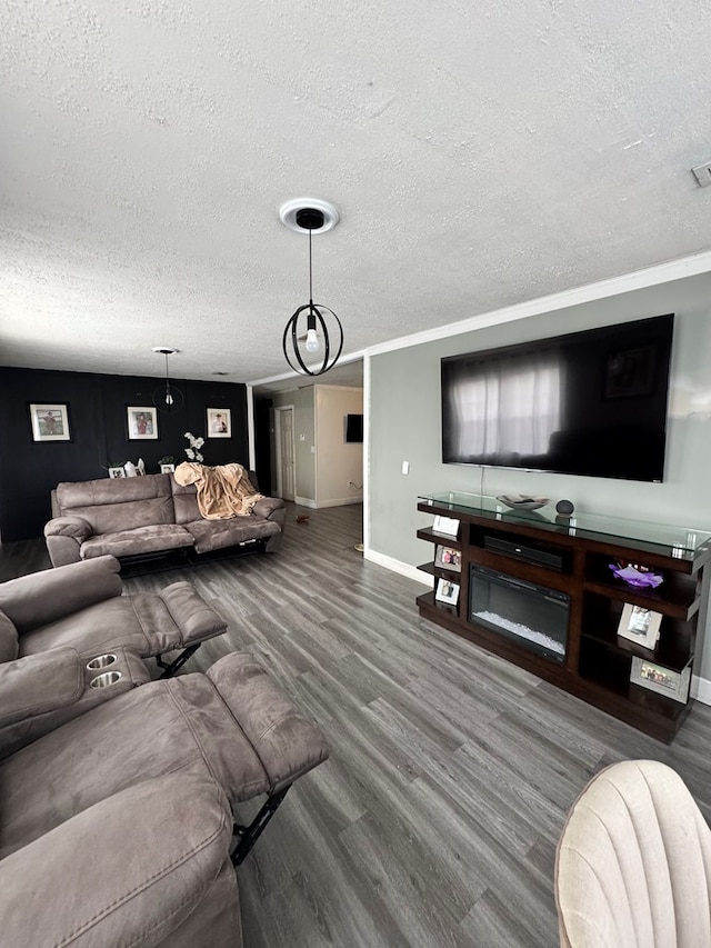 living area featuring baseboards, visible vents, wood finished floors, and a textured ceiling