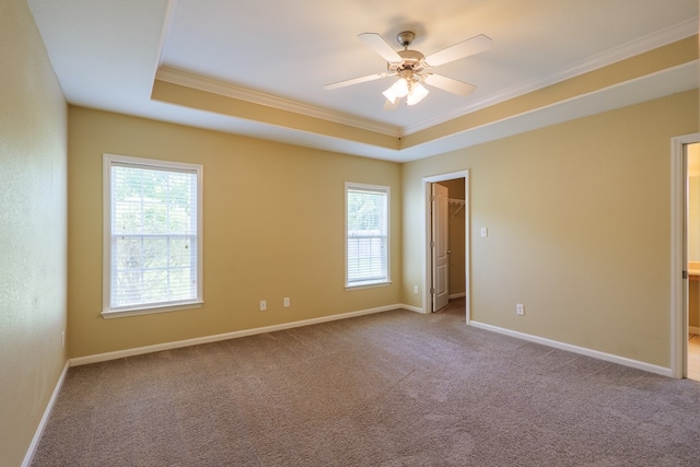 5702 Emily Ln, Hahira, GA 31632 - unfurnished bedroom featuring ornamental molding, a raised ceiling, multiple windows, and carpet flooring